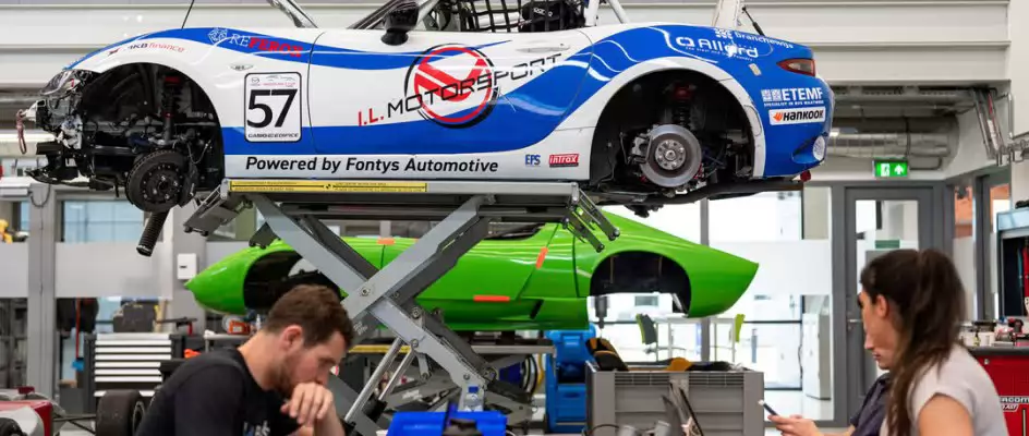 students working in a car garage