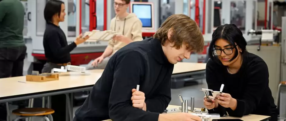 Students working on mechanical parts