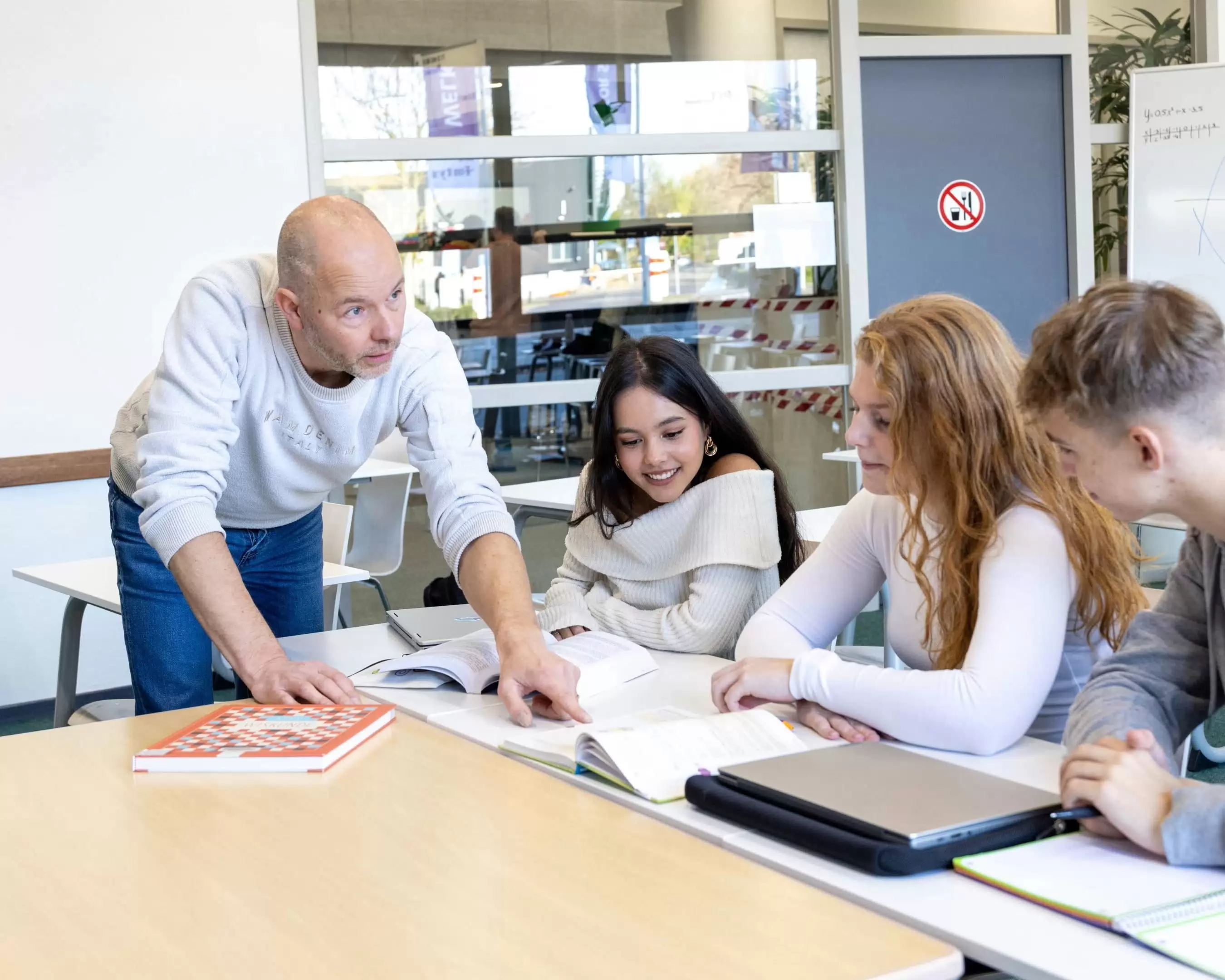 Een deeltijdstudent Leraar Biologie werkt buiten aan een laptop