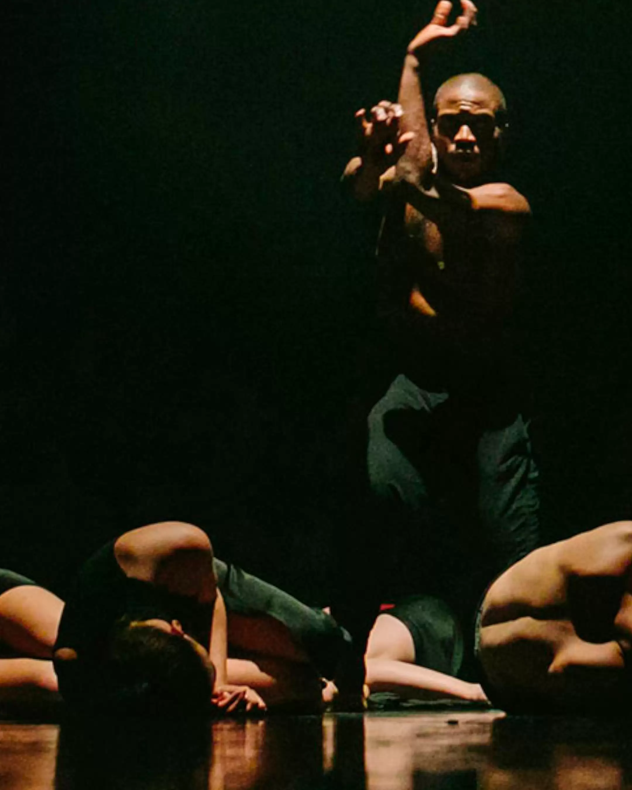 A student is dancing in a dark studio