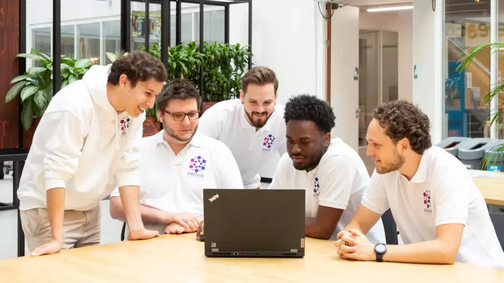 PROUD students looking at a laptop