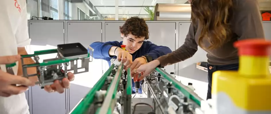Students working on a machine