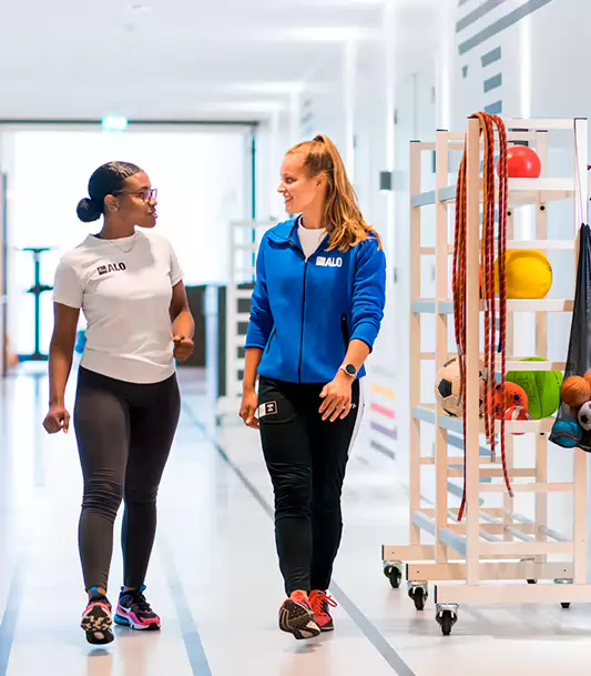 Two sport students walking