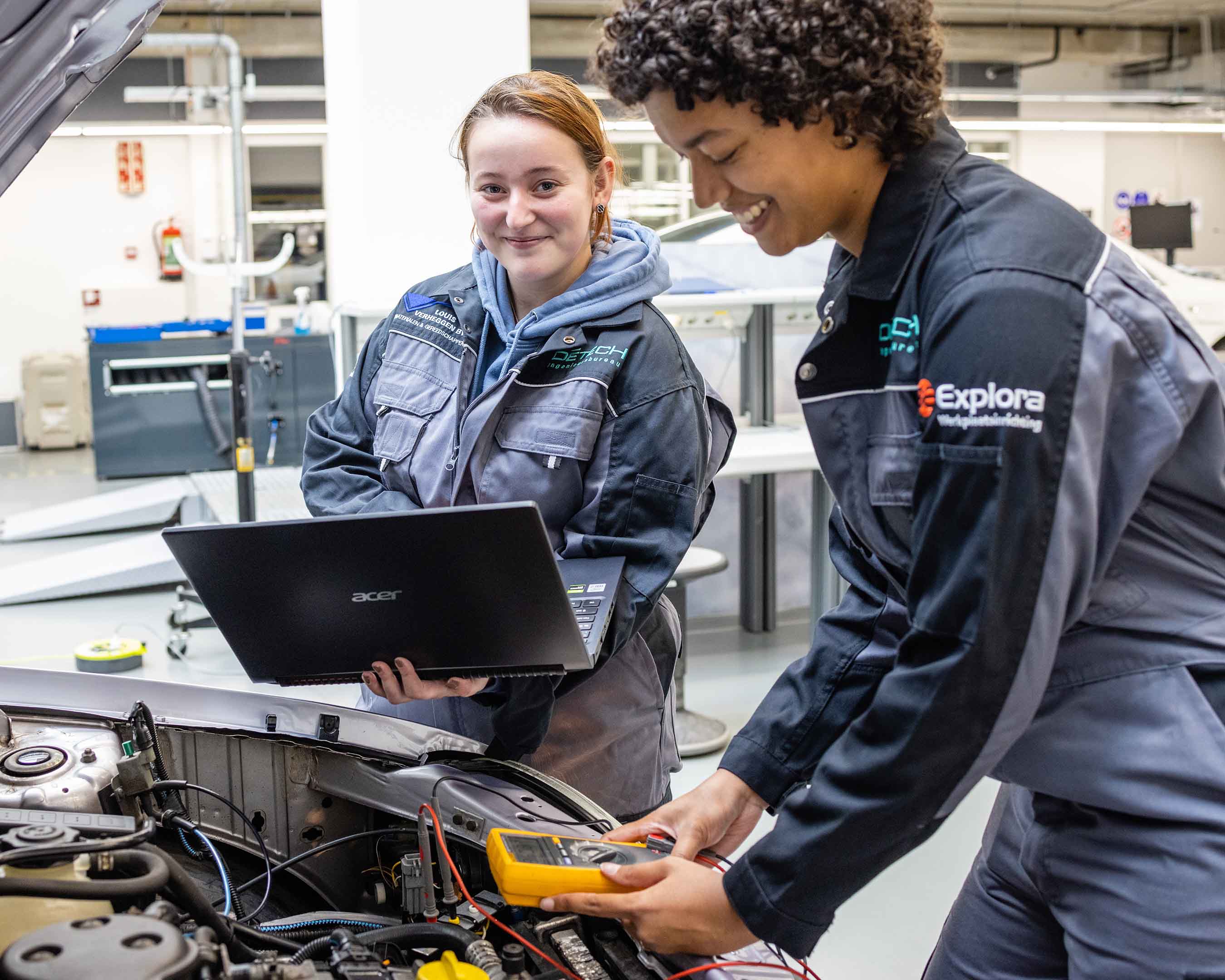 Two students working on car