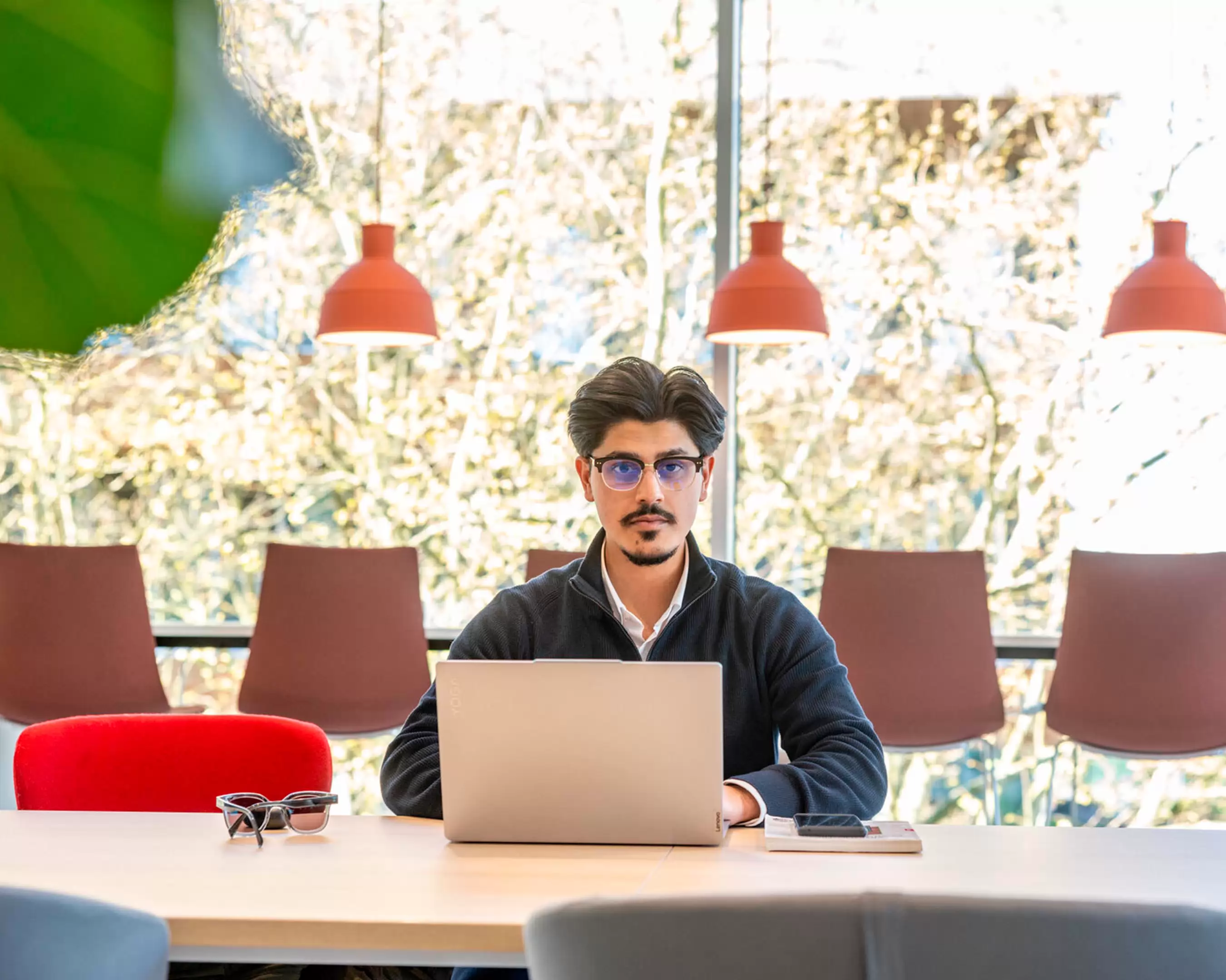 student with laptop looking at camera