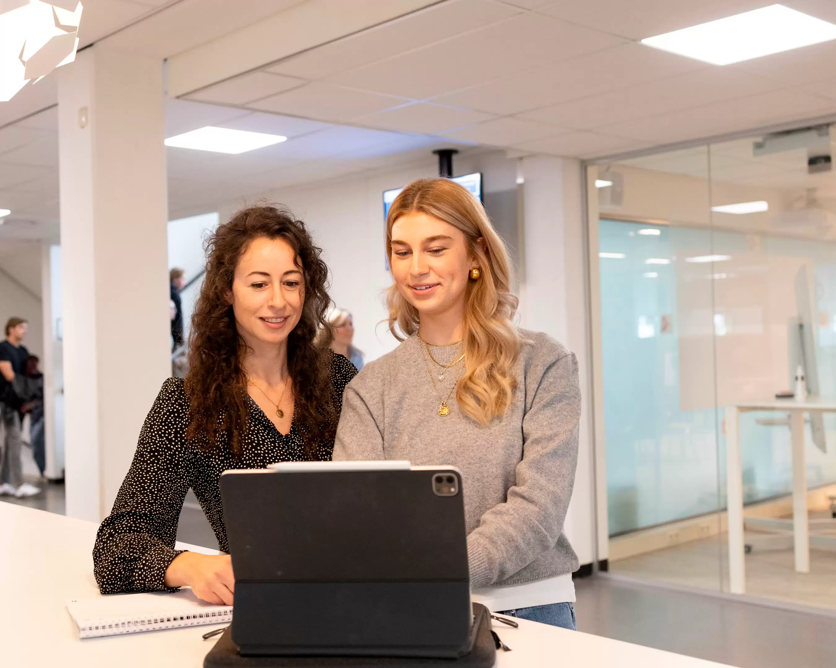 Two students looking at a laptop