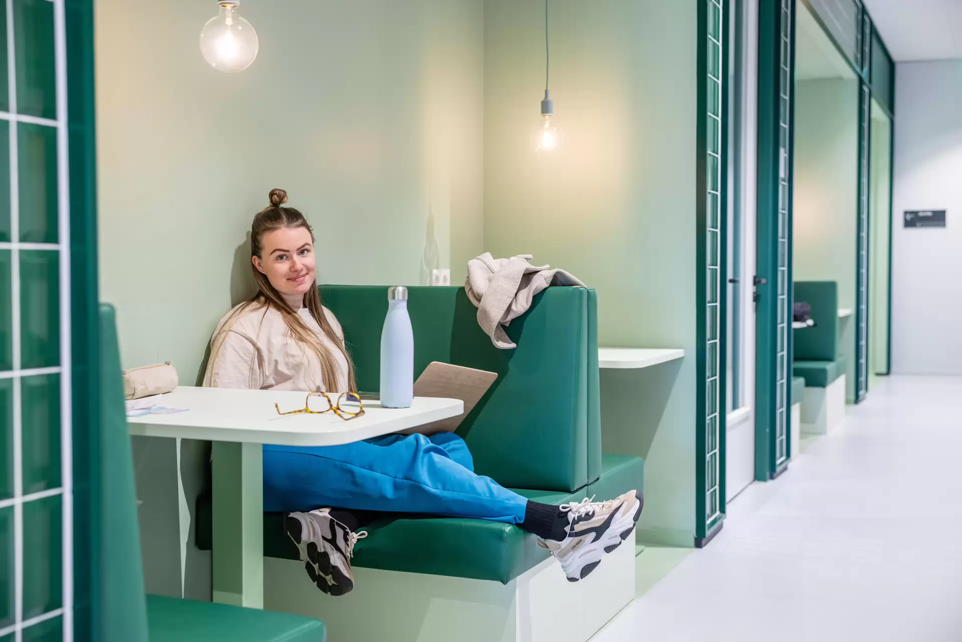 student with laptop looking at camera