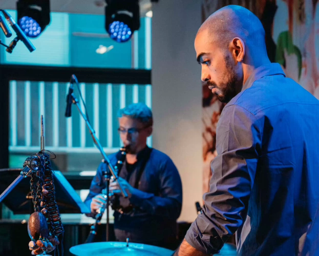 a student from the bachelor programme Fontys Conservatory of Music is practicing at school with drums and clarinet