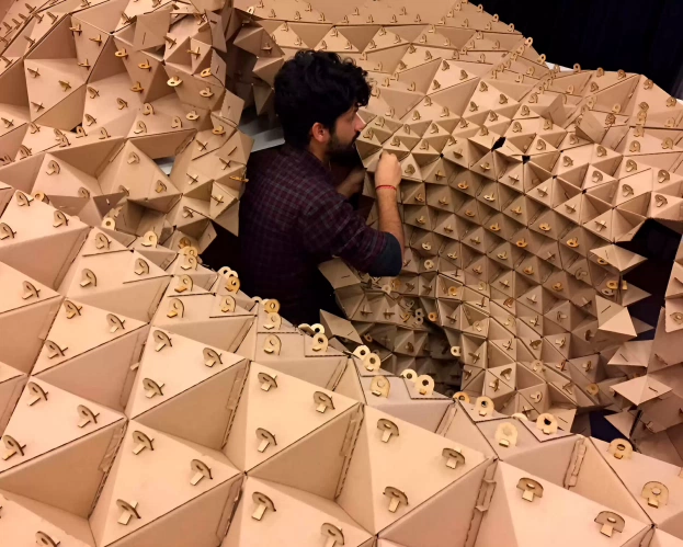  A student from the master Architecture is working on his project with cardboard 